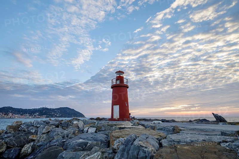 Sunrise with lighthouse at the harbour pier in Porto Maurizio