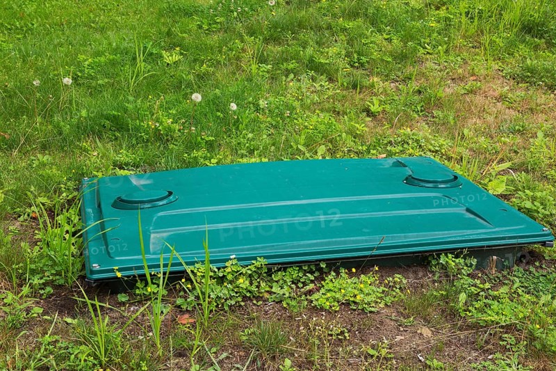 Septic tank cover in residential backyard