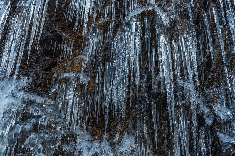 Icicles forming an icefall in the mountain in winter. France