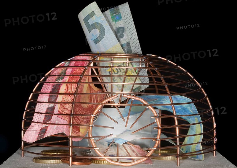 Euro coins and paper money lying in a live trap for mice