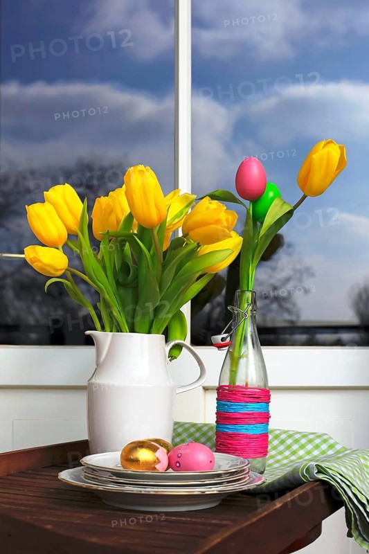 Bouquet of tulips and Easter eggs on a balcony
