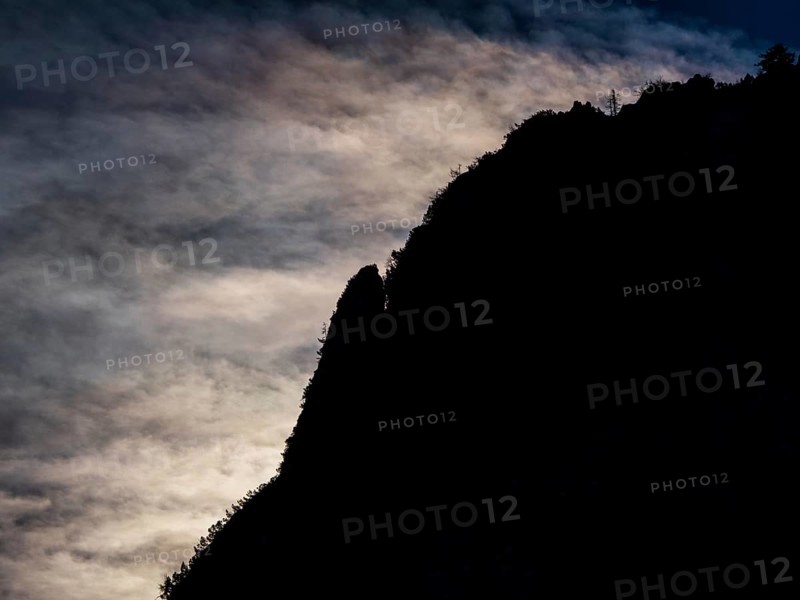 Clouds over mountain silhouette