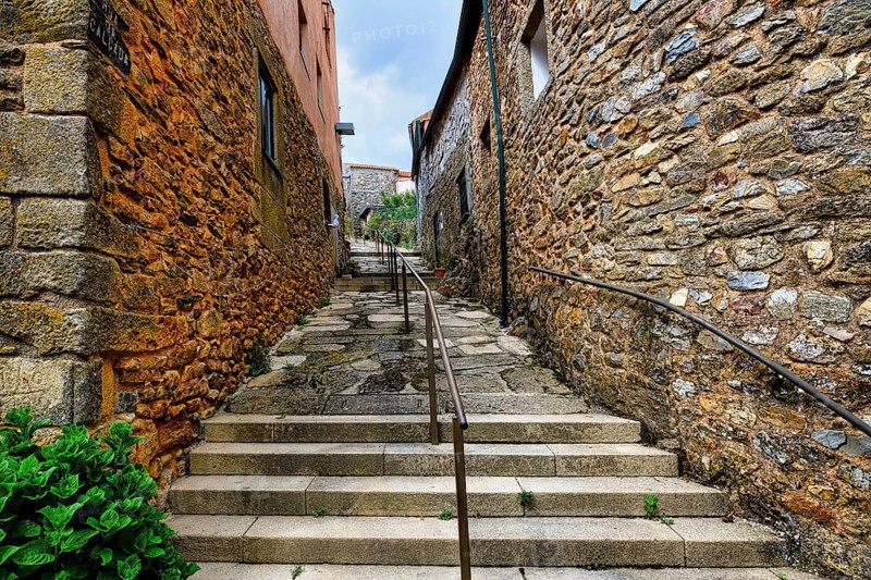 Narrow street with flowers and old stone houses