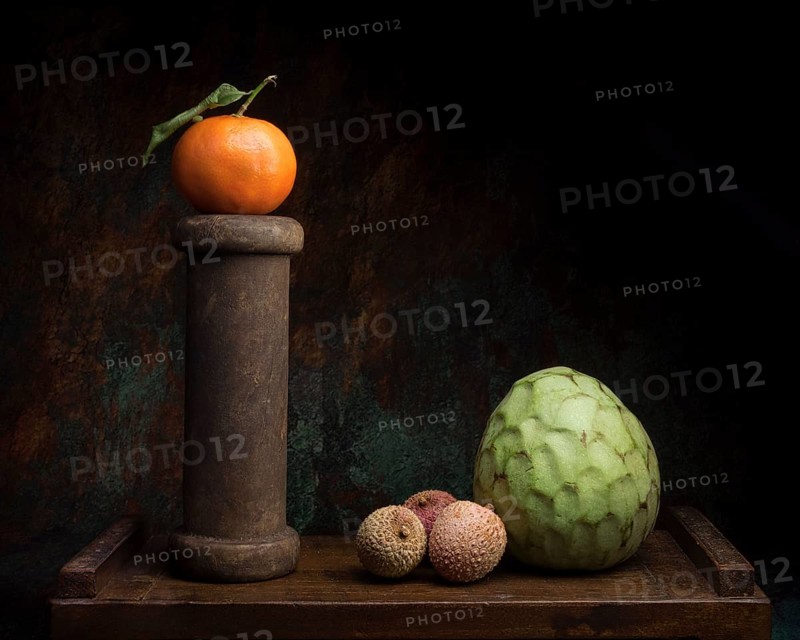 Still life with mandarin on wooden spool