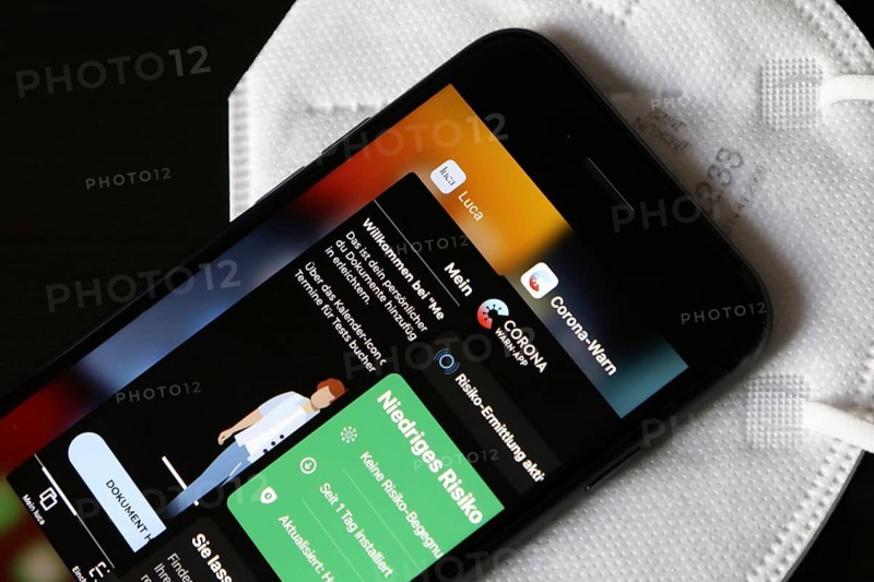 FFP2 mask and iPhone with Corona warning app and Luca app
