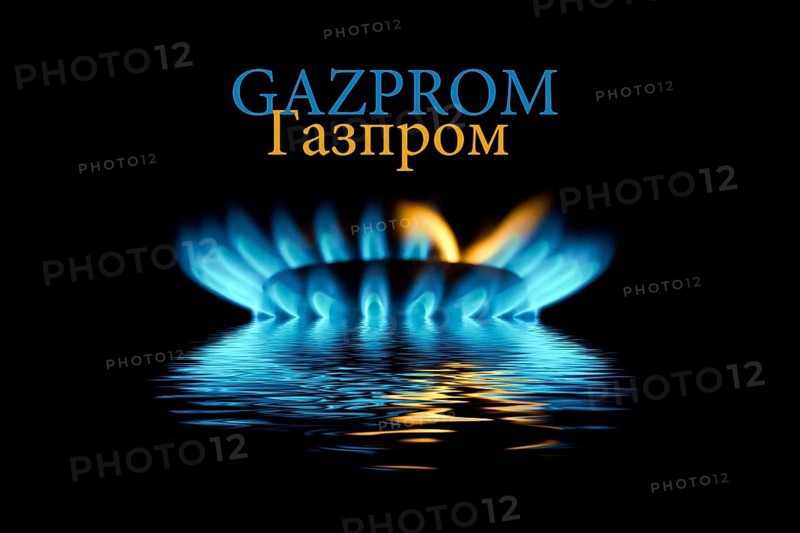 Gas flame with Gazprom logo reflected in the water