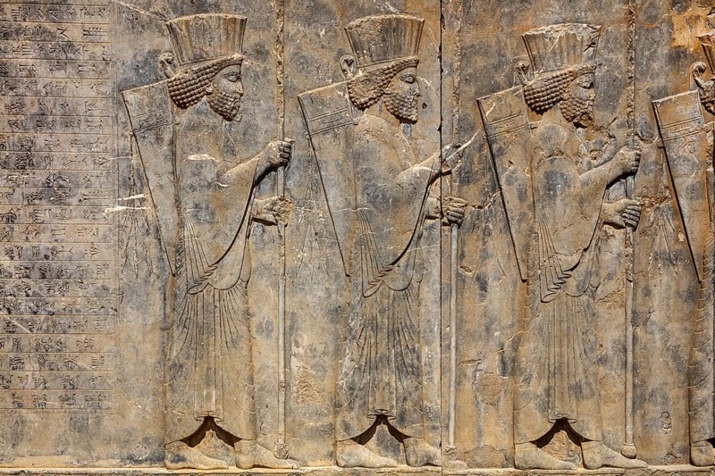 Persian guards at the west staircase of Darius Palace with cuneiform writing