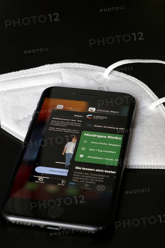FFP2 mask and iPhone with Corona warning app and Luca app