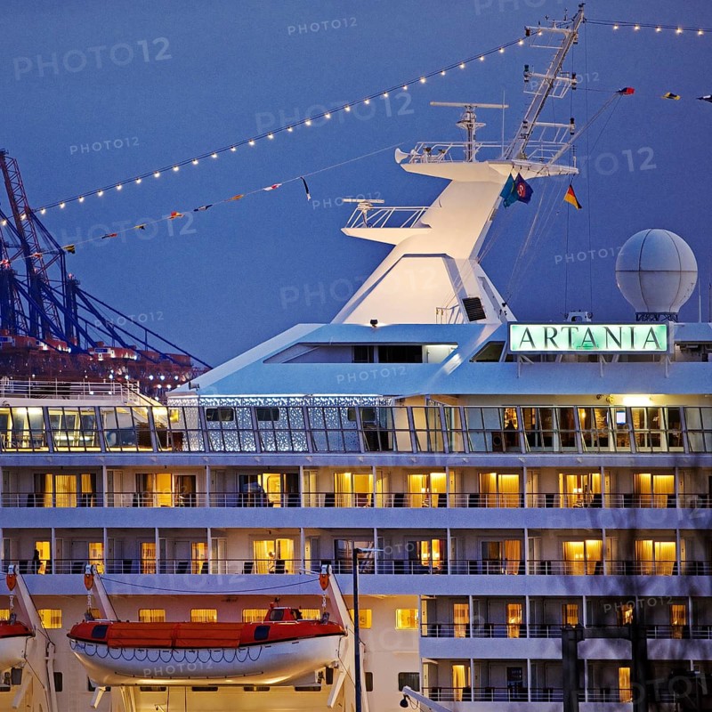 Cruise ship Artania at Hamburg Cruise Center Altona with the cranes of the harbour in the background