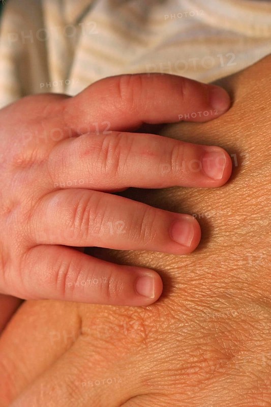 Baby hand on adult hand
