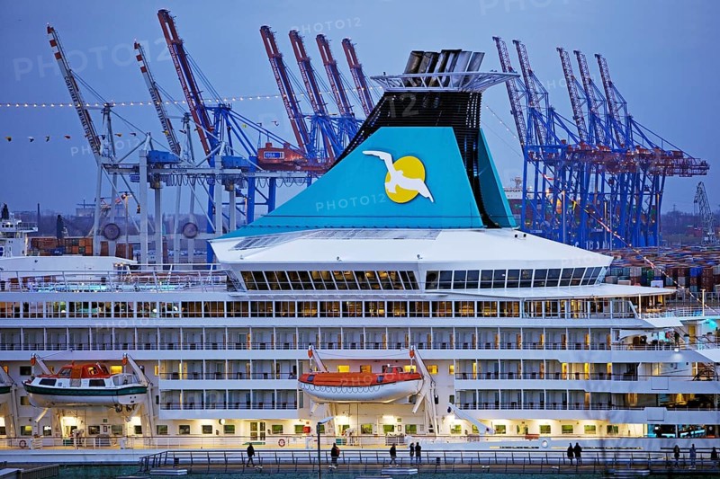 Cruise ship Artania at Hamburg Cruise Center Altona with the cranes of the harbour in the background