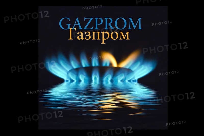 Gas flame with Gazprom logo reflected in the water