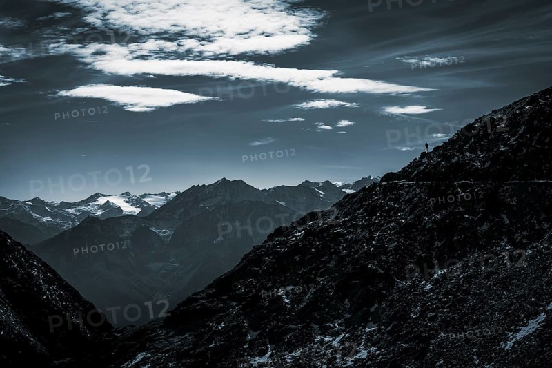 Mountaineers on mountain ridge in the background glaciated mountains