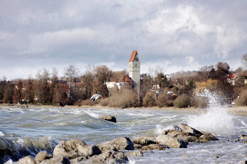 Storm Lolita whips waves against the stony shore in the background Hagnau