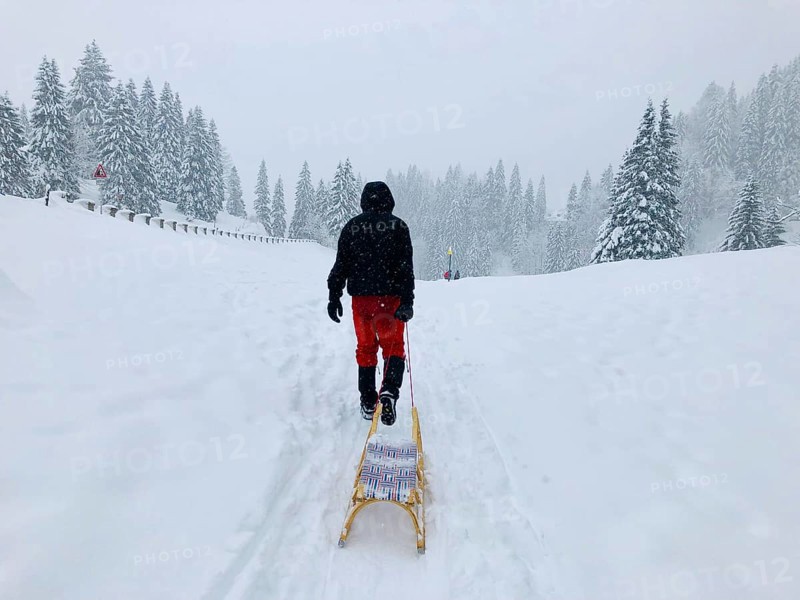 Man pulling a sledge through the snow