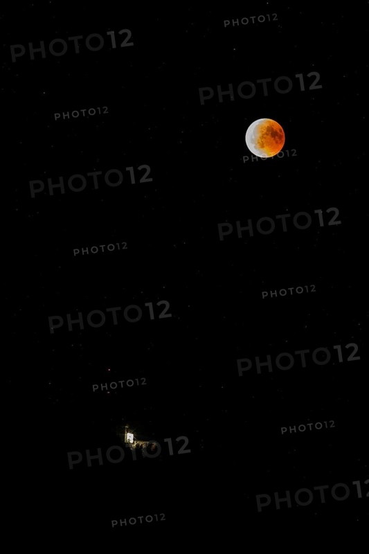 Lunar eclipse over the mountain station of the Saentisbahn