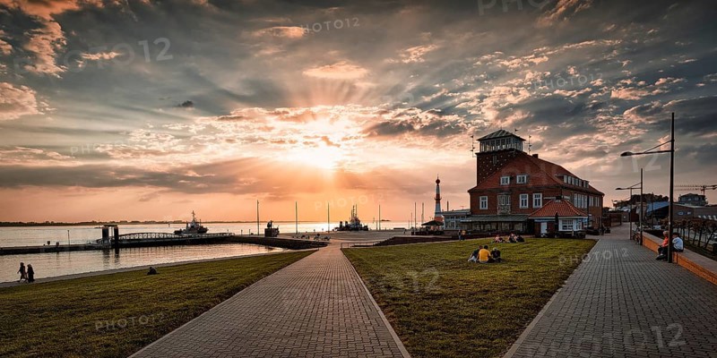 View of the Weser estuary and Strandhalle at sunset from the dyke