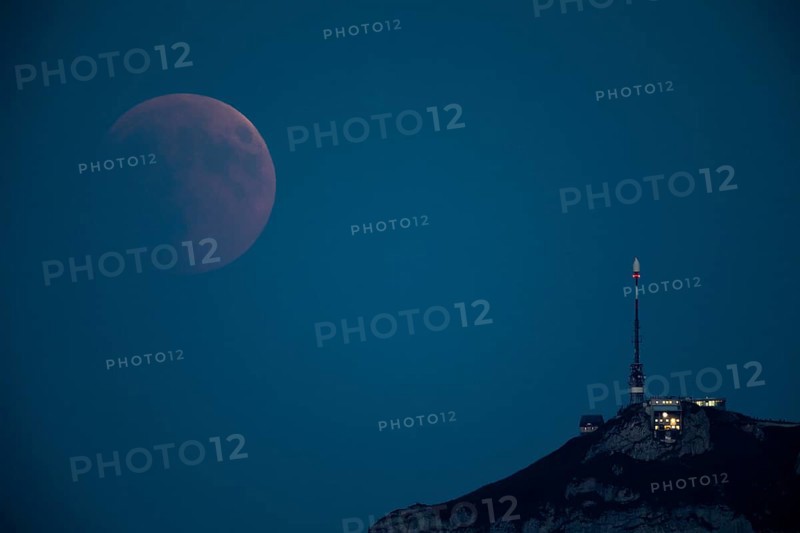 Lunar eclipse above the mountain station of Hohen Kasten