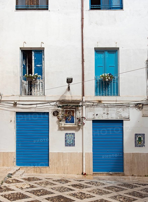 Blue doors and windows on white facade