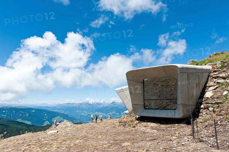 Two large futuristic windows rise out of the mountain