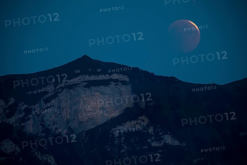 Lunar eclipse above the mountain station of Hohen Kasten