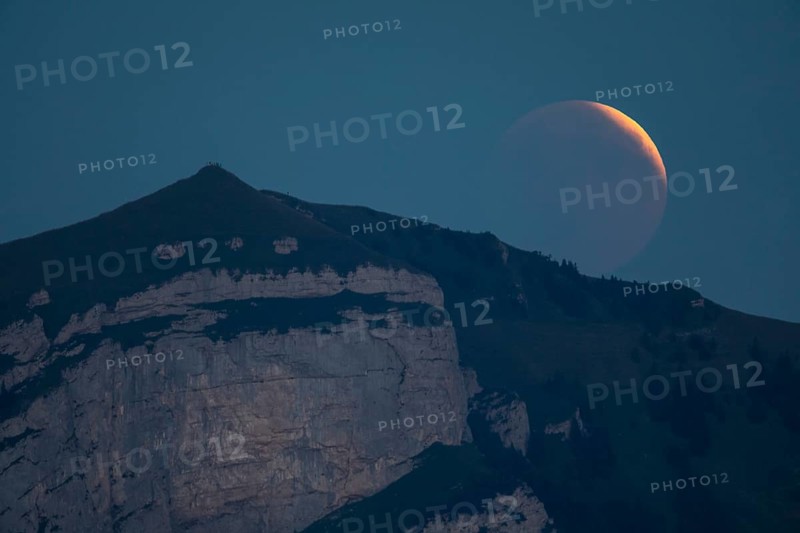 Lunar eclipse above the mountain station of Hohen Kasten