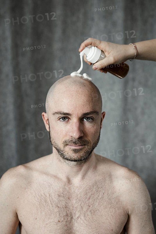 Man gets shaving foam sprayed on his bald head