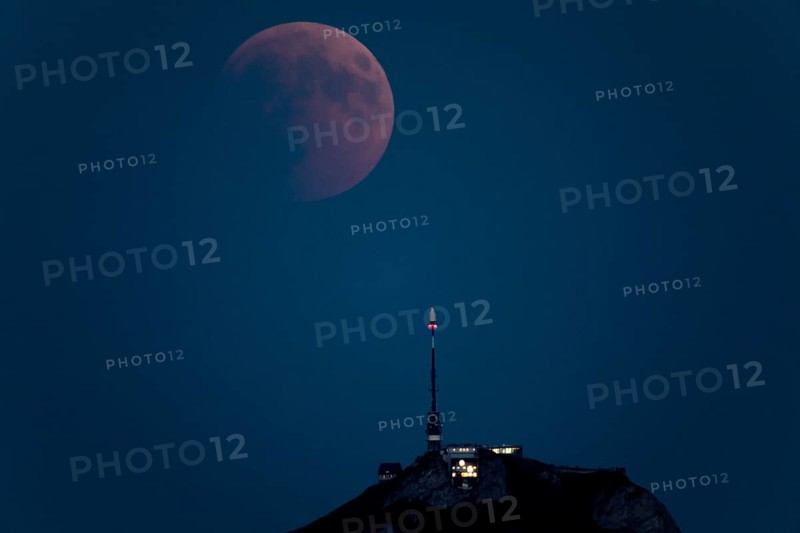 Lunar eclipse above the mountain station of Hohen Kasten
