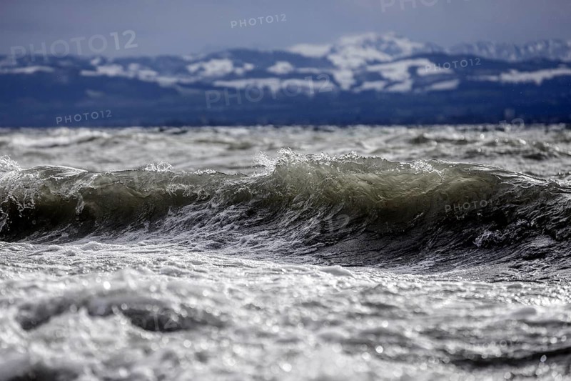 Storm Lolita raging on the rocky shore with waves in Hagnau