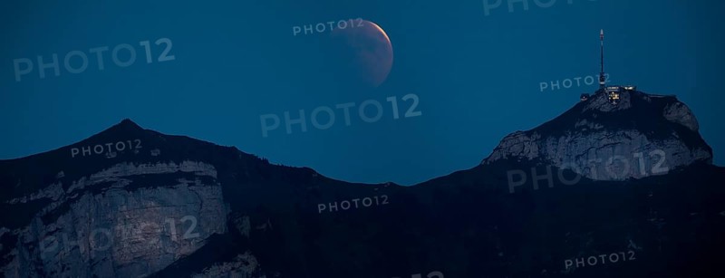 Lunar eclipse above the mountain station of Hohen Kasten