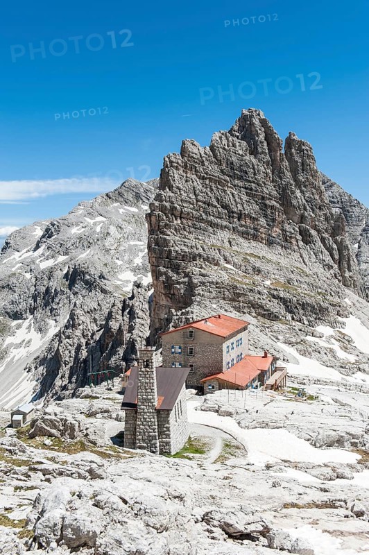 Alpine refuge Rifugio Pedrotti and chapel with rock Croz del Rifugio