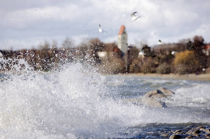 Storm Lolita whips waves against the stony shore in the background Hagnau