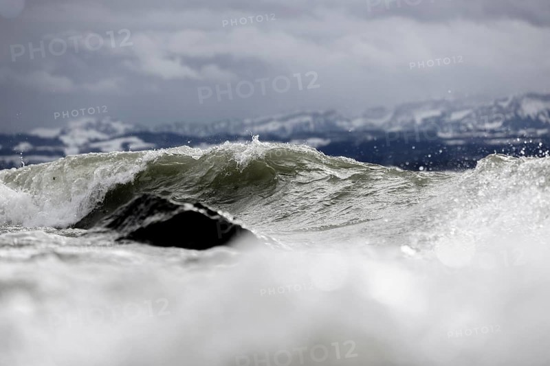 Storm Lolita raging on the rocky shore with waves in Hagnau