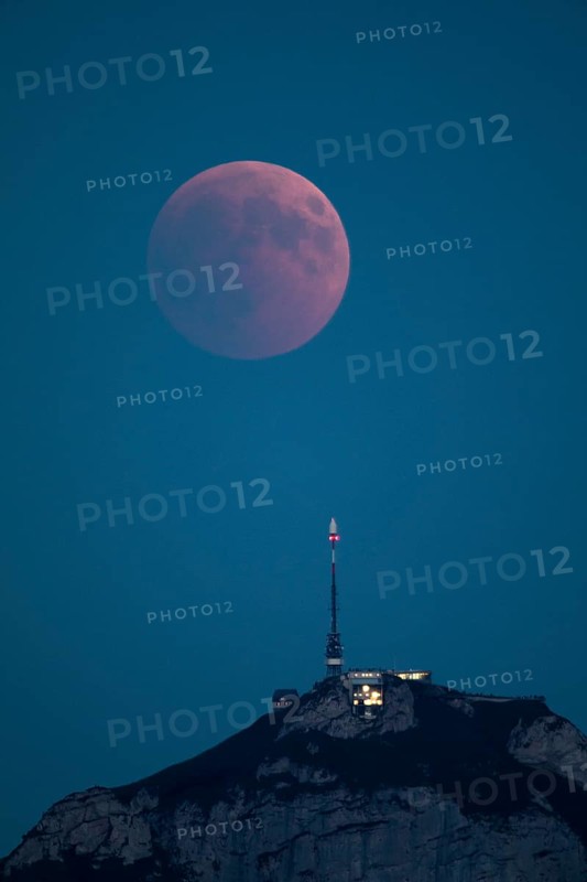 Lunar eclipse above the mountain station of Hohen Kasten