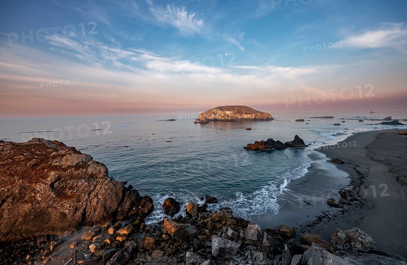 Sandy beach beach Harris Beach with rocks at sunrise