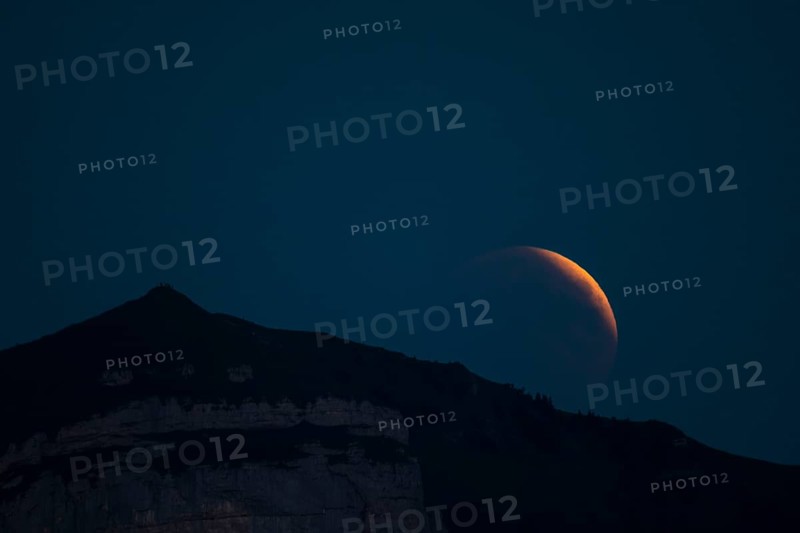 Lunar eclipse above the mountain station of Hohen Kasten
