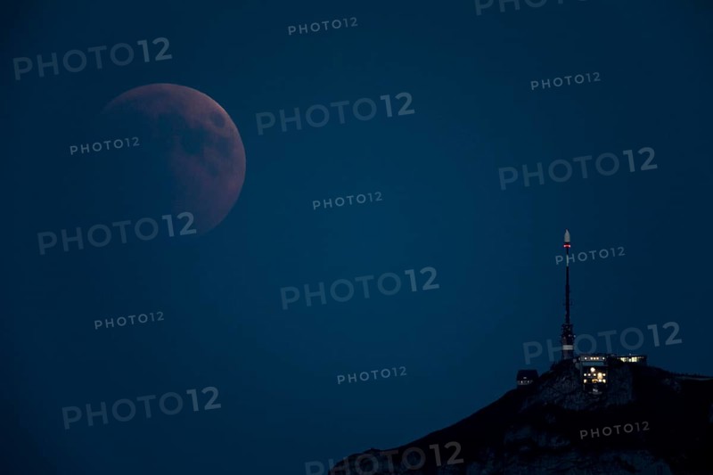 Lunar eclipse above the mountain station of Hohen Kasten