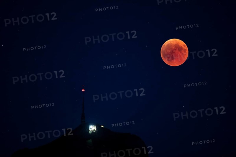 Lunar eclipse above the mountain station of Hohen Kasten