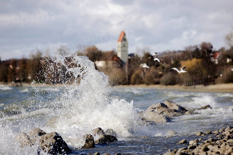 Storm Lolita whips waves against the stony shore in the background Hagnau