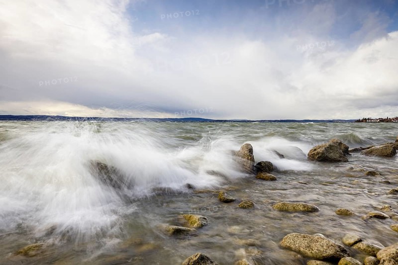 Storm Lolita raging on the rocky shore with waves in Hagnau