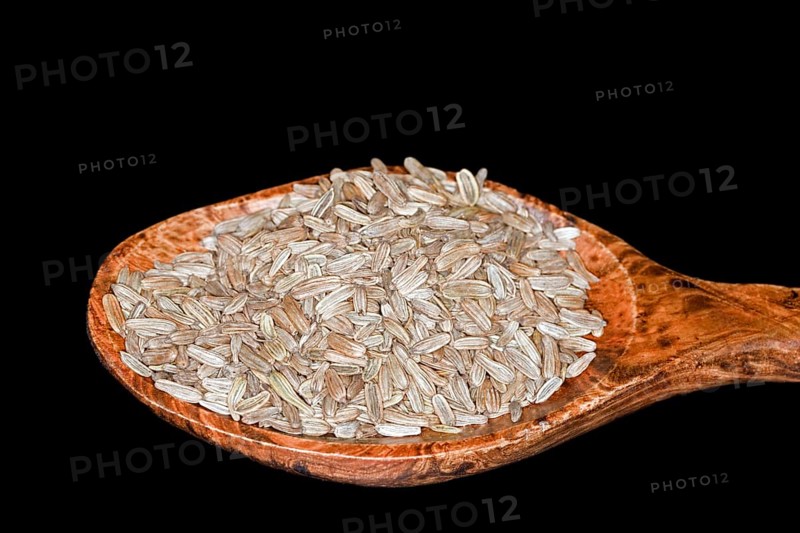 Fennel seeds lying in a wooden spoon