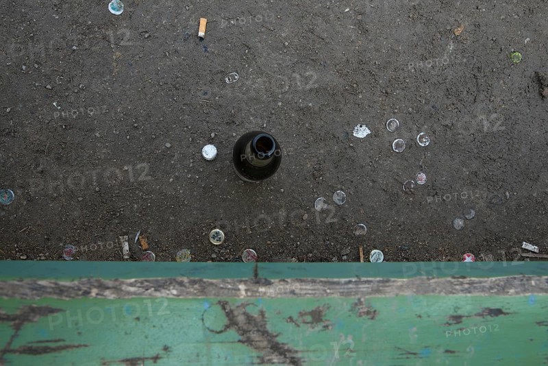 Empty beer bottle on a park bench at Heidelberger Platz