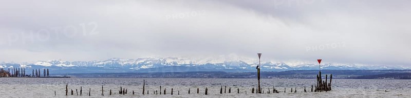 Old wooden groynes at low water and storm on Lake Constance