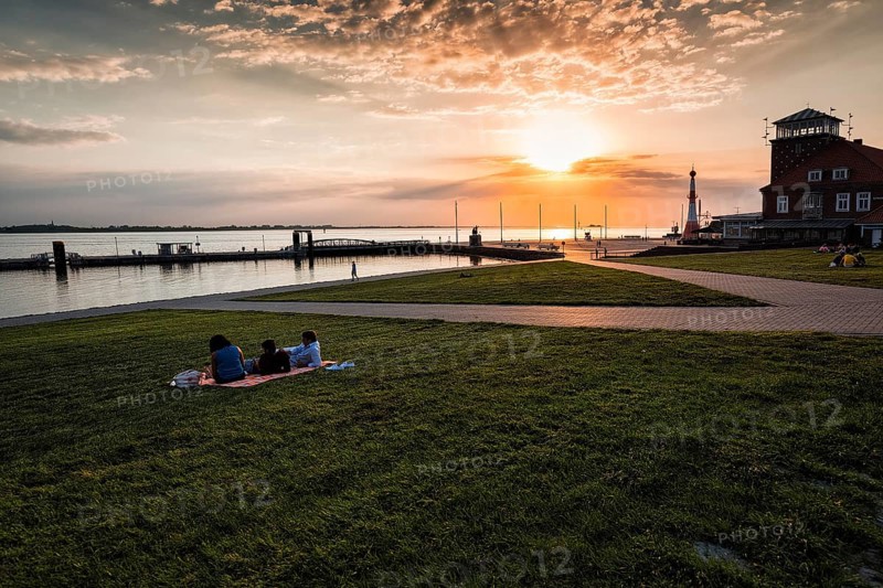 View of the Weser estuary and Strandhalle at sunset from the dyke