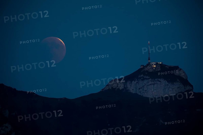 Lunar eclipse above the mountain station of Hohen Kasten