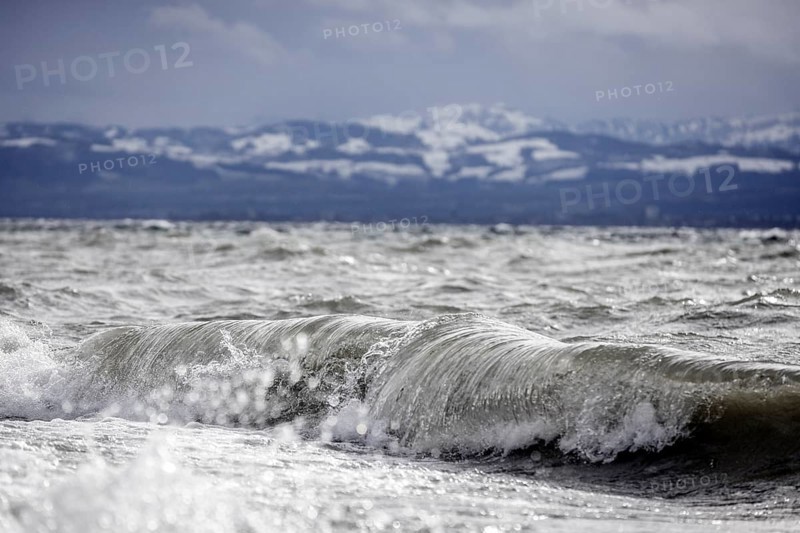 Storm Lolita raging on the rocky shore with waves in Hagnau