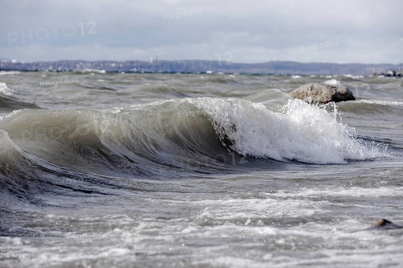 Storm Lolita raging on the rocky shore with waves in Hagnau