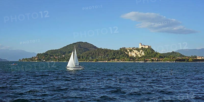 Sailing boat and castle of Angera or Rocca Borromeo di Angera