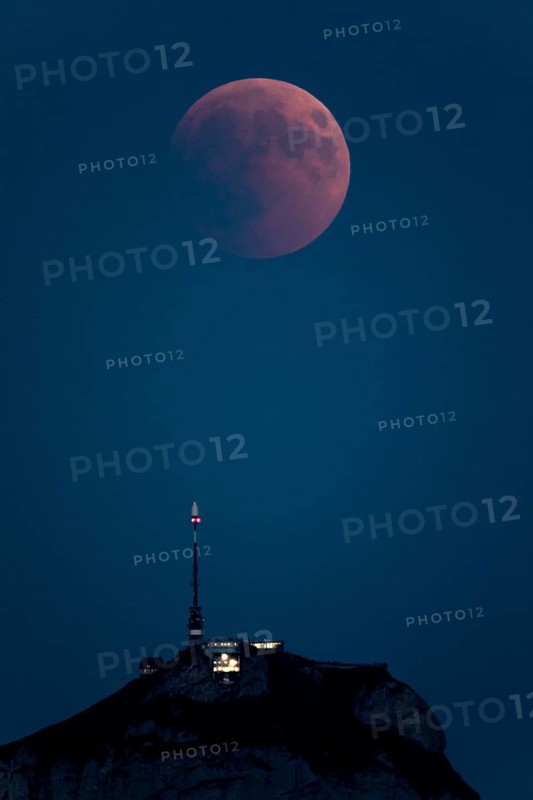 Lunar eclipse above the mountain station of Hohen Kasten