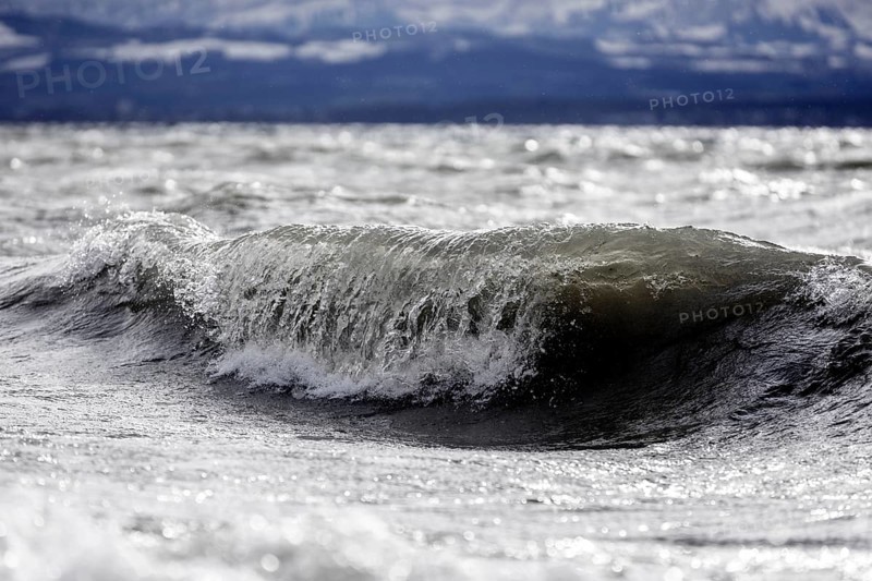 Storm Lolita raging on the rocky shore with waves in Hagnau